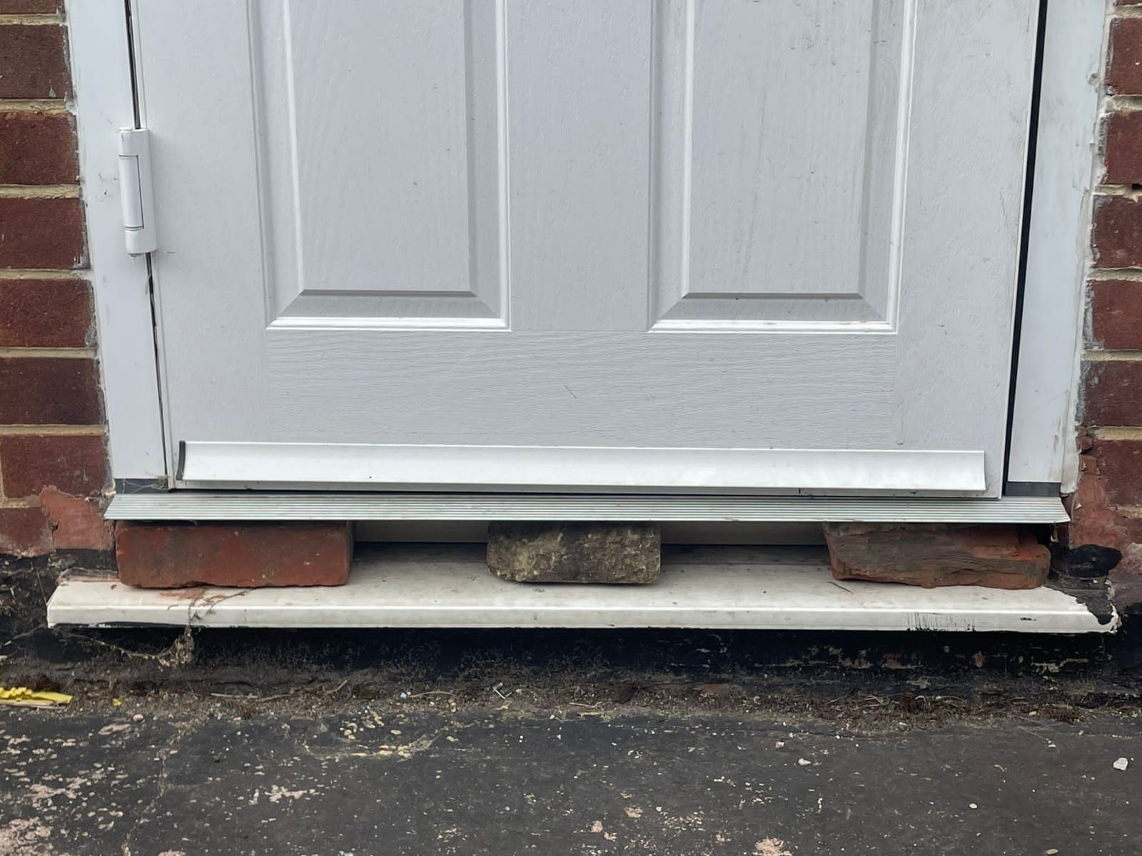 mobile locksmith repairs and levels a front door away from unsafe methods